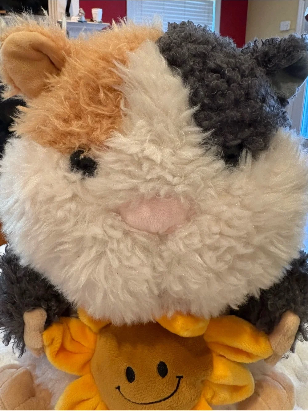 24” Russ sunflower cuddle Guinea Pig Plush holding a small yellow sunflower
